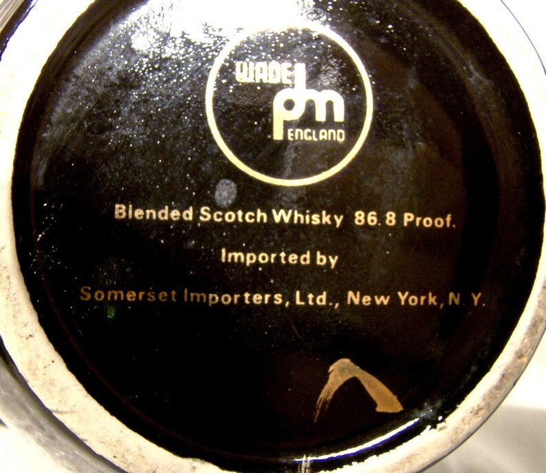May include: Black and gold label on a bottle of blended Scotch whisky. The label reads "Wade pm England" and "Blended Scotch Whisky 86.8 Proof. Imported by Somerset Importers, Ltd., New York, N.Y."