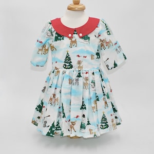 Size 4. Classic Christmas icons make appearances on this white short-sleeved dress for a little girl. Ready to ship!