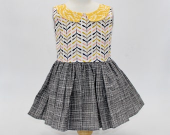 Size 2T. Calming shades of yellow, gray and pink cover this dress accented w/a yellow patterned collar for a little girl. Ready to ship!