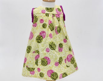 Size 18-24 mo. Circles of Flowers! Shades of green and circles of fuchsia cover this sleeveless dress/tunic for a little girl. Ready to ship
