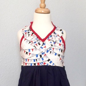 Ode To Pennants! Gray, red and blue pennants cover this lined halter dress w/a navy blue skirt, ruffled neckline & red straps - Girls Size 7