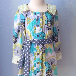 Girls Size 3T. Shades of green and gray flowers abound on this long sleeve button down dress with a gray and white sash. Ready to ship!