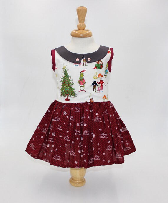 Size 2T. Classic Christmas icons are featured on this sweet sleeveless  Christmas dress for a little girl. Ready to ship!