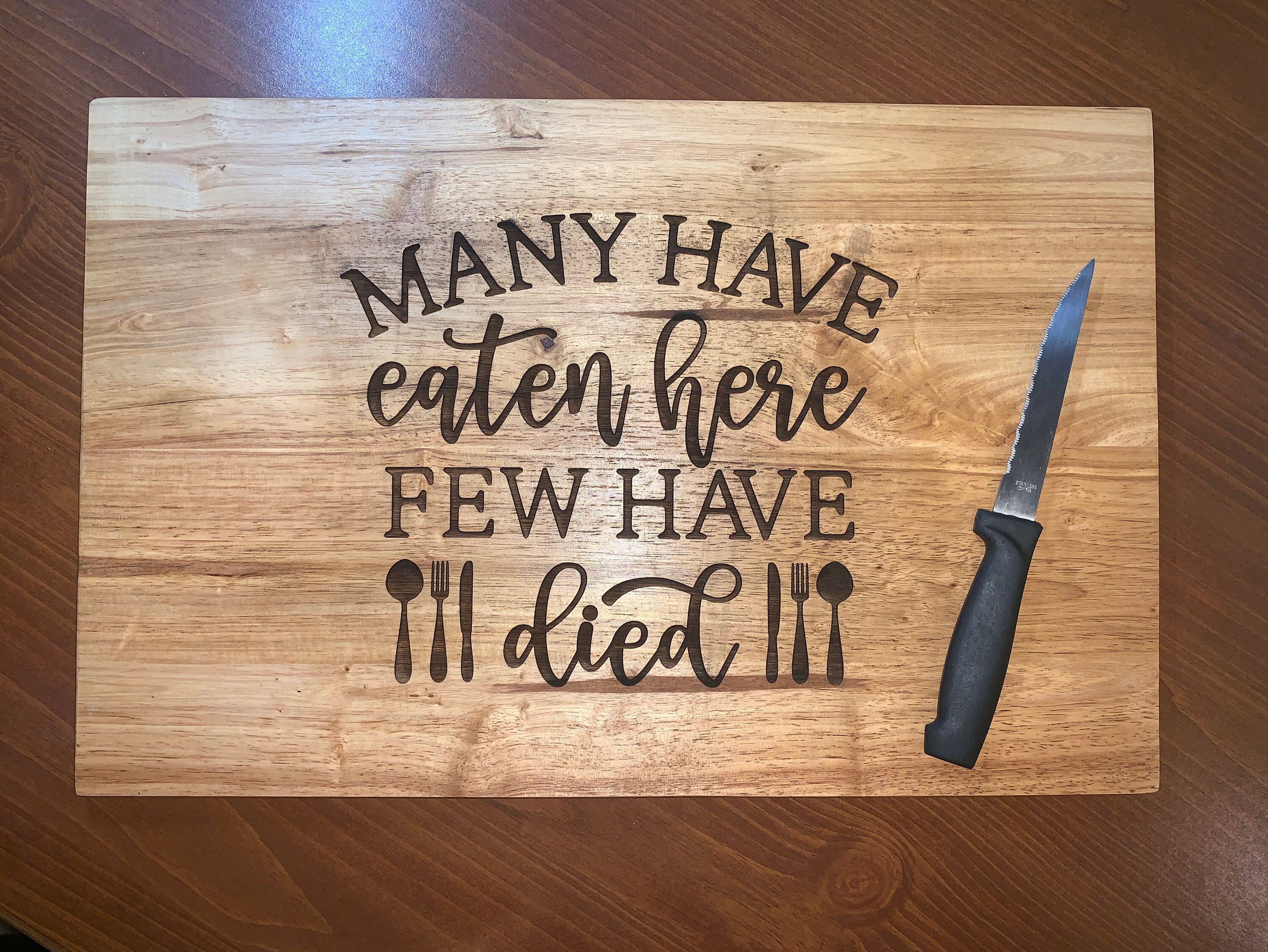 Download Many Have Eaten Here Few Have Died Cutting Board