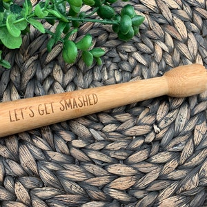 May include: A wooden cocktail muddler with the text "Let's Get Smashed" engraved on it.