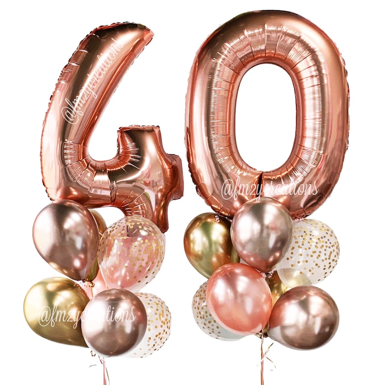 May include: Rose gold number 40 balloons with confetti balloons and rose gold, gold, and clear balloons. The balloons are tied together with strings.