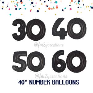 May include: Four black 40 inch number balloons, 30, 40, 50, and 60, against a white background with confetti.  The balloons are for a birthday party or other celebration.