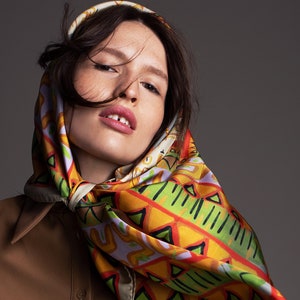 Printed colorful square silk scarf with an original ethnic pattern by designer Dikla Levsky. Orange, Green, Tan brown, Lilac, Grey foulard