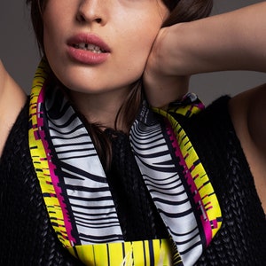 Printed skinny scarf in vibrant colors. Double sided narrow twill silk scarf with bias cut edges. Neon yellow, Pink, Black, Grey.