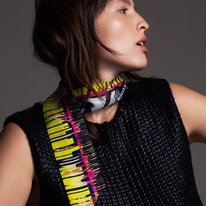 Printed skinny scarf in vibrant colors. Double sided narrow twill silk scarf with bias cut edges. Neon yellow, Pink, Black, Grey.