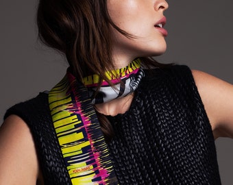 Skinny printed silk twill scarf. Long and narrow barcode print double sided scarf with diagonal edges. Neon Yellow, Black, Pink, Grey.