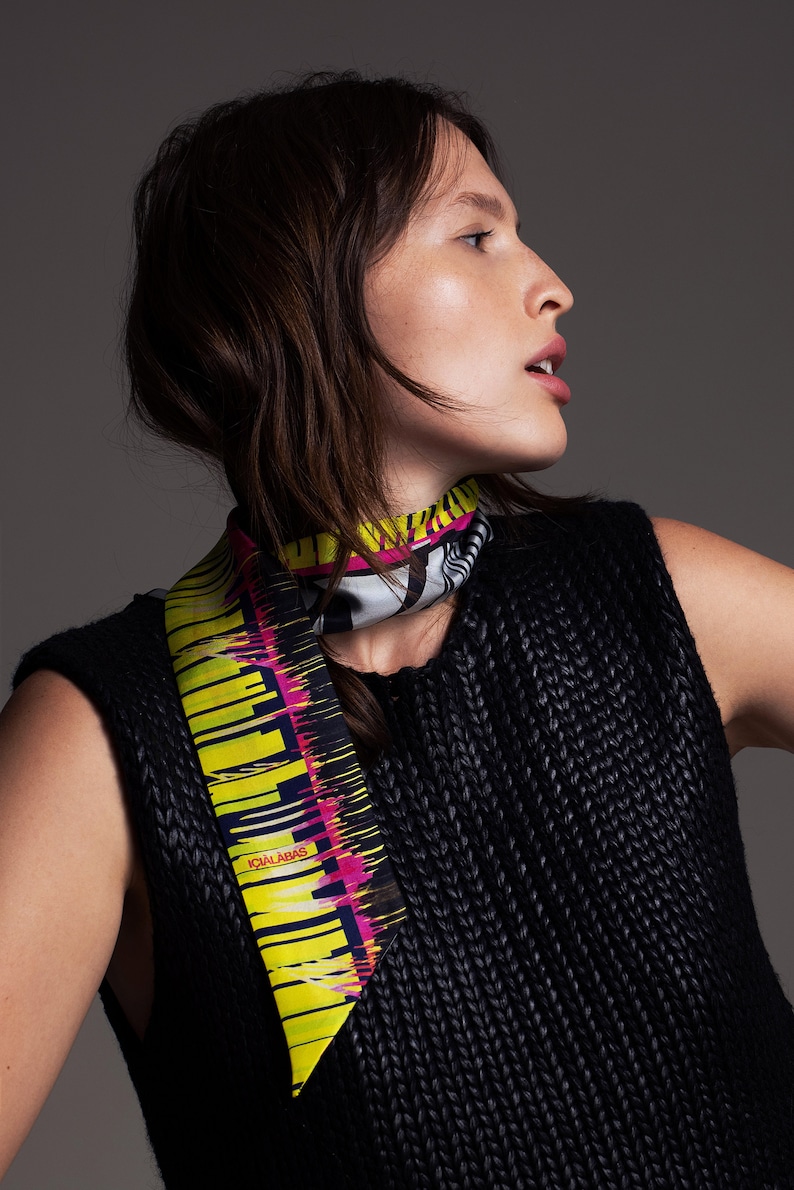 Printed skinny scarf in vibrant colors. Double sided narrow twill silk scarf with bias cut edges. Neon yellow, Pink, Black, Grey.