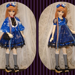 May include: A blue and white doll with long blonde hair wearing a blue dress with a white star pattern and a blue jacket with white stars. The doll is wearing black and white striped stockings and black shoes.