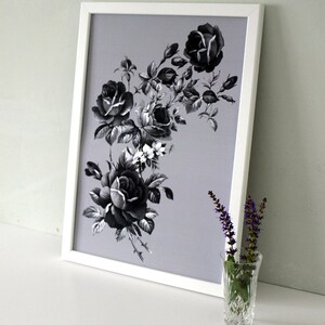 May include: A black and white framed print of a floral arrangement featuring black roses and white flowers on a light gray background.