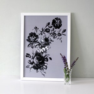 May include: A framed black and white print of a floral arrangement featuring roses and leaves on a light purple background.