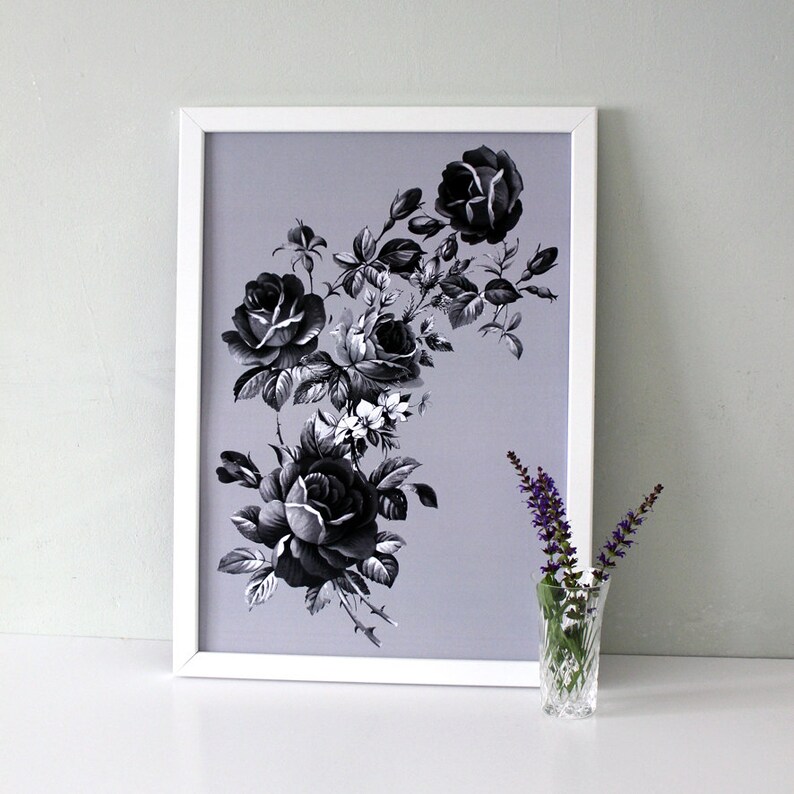 May include: A framed black and white print of a floral arrangement featuring roses and leaves on a light purple background.