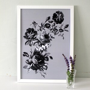 May include: A framed black and white print of a floral arrangement featuring roses and other flowers on a light gray background.