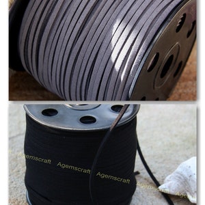 May include: Two spools of suede cord, one grey and one black, are shown. The grey cord is tightly wound on a spool, highlighting its texture. The black cord is also wound on a spool, with a length of cord extending out. The spools are made of metal.