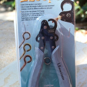 May include: A package featuring a 1-Step Looper tool for making eye pins. The tool is black and grey with grey handles. The packaging includes text in English, French, and Spanish, and the tool is for wire between 0.511mm and 1.020mm.