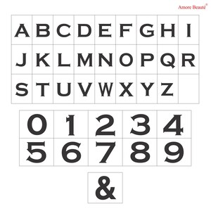 May include: Black and white alphabet and number stamps with a single ampersand stamp. The stamps are arranged in rows on a white background.