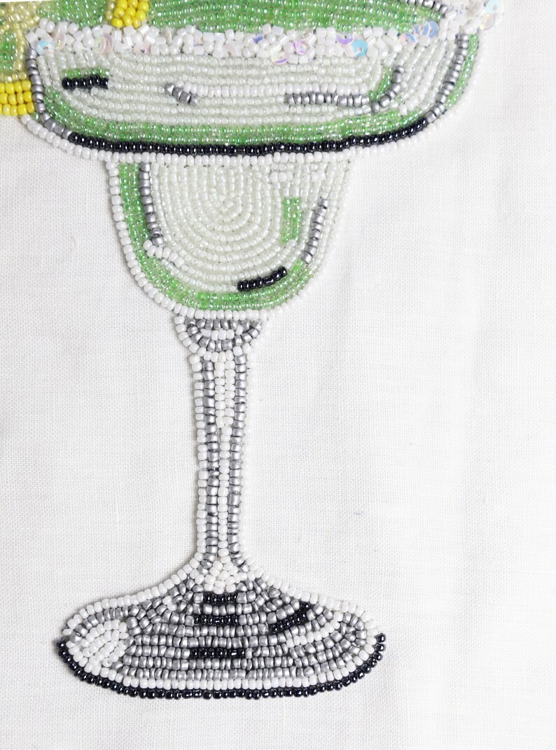 Choose this unique piece of wall decor and impress your guests with its artistic flair. Beaded margarita drink made of grey, silver, black, green and white beads. Sure, there are yellow ones to add the hint of lime in the drink.
