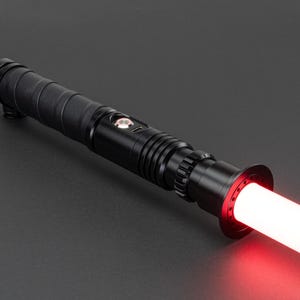 May include: A black lightsaber with a red blade. The lightsaber has a textured grip and a black emitter.