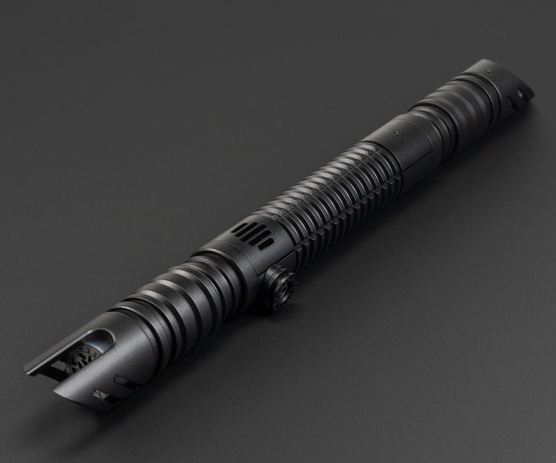 May include: A black lightsaber with a textured grip and a detailed hilt. The lightsaber is made of metal and has a sleek, modern design.