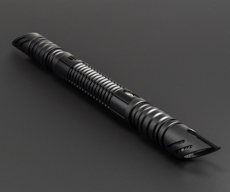 May include: A black lightsaber with a textured grip and a pointed tip.