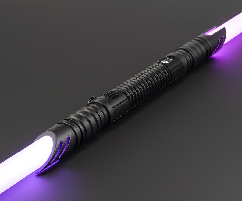 May include: A black lightsaber with a purple blade. The lightsaber has a textured grip and a black emitter.