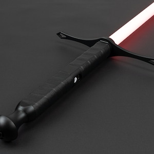 May include: A black lightsaber with a red blade and a textured handle. The lightsaber has a crossguard and a round pommel.