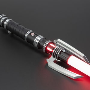 May include: A black lightsaber with a red blade and a silver handle. The lightsaber has a unique design with a claw-like emitter.