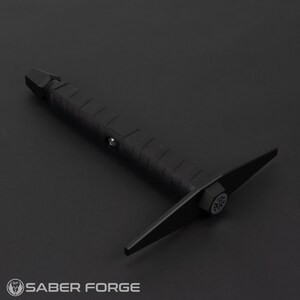 May include: A black,  metal,  hand-held tool with a  sharp,  pointed tip and a  flat,  wide blade. The tool has a  textured,  black handle.