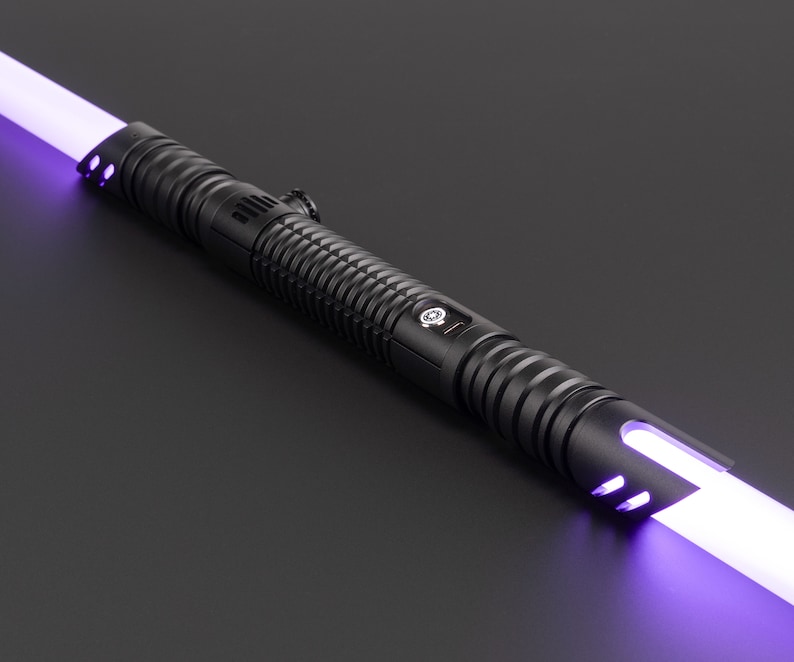 May include: A black lightsaber with a purple blade. The lightsaber has a textured grip and a silver button.