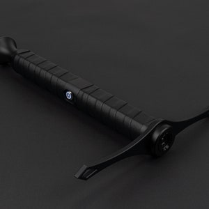 May include: A black handheld inspection camera with a flexible, extendable arm. The camera has a small, round lens and a textured grip.