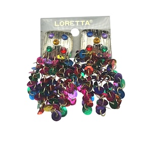 May include: A pair of Loretta brand earrings on a display card. Each earring features a textured gold-tone square top accented with small multicolored rhinestones, from which hang numerous dangling circular sequins in vibrant shades of red, blue, green, and purple.