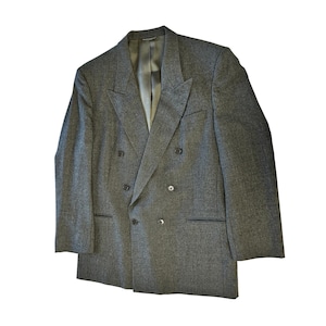 May include: A gray double-breasted blazer with a notched lapel. The blazer has six buttons and two front pockets. The interior lining is a light gray color. The blazer is made of a textured fabric.