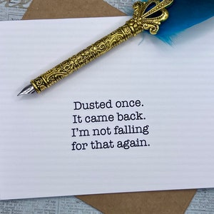 May include: A white card with black text that reads "Dusted once. It came back. I'm not falling for that again."