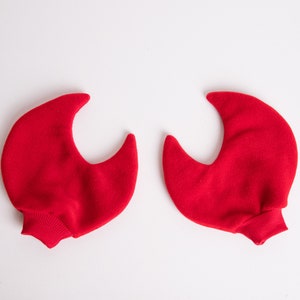 May include: A pair of red felt hand puppets shaped like claws.