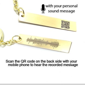 May include: Gold-toned keychain with a rectangular tag engraved with a soundwave pattern. The back of the tag has a QR code. The image includes instructions on how to personalize the keychain with a recorded sound message.