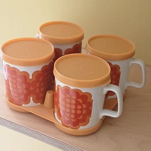 Staffordshire potteries vintage mug set. Flower power orange 70s design. Mid century Floral Mug with lids. Made in England.