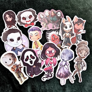 May include: A collection of colorful stickers featuring cartoon illustrations of horror movie characters. The stickers showcase various characters with distinct facial expressions and attire, set against a dark background. The stickers are of various sizes and shapes.