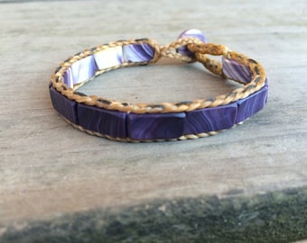 Flat Bead Wampum Bracelet with False Sinew Braid. Available on black sinew or natural sinew.