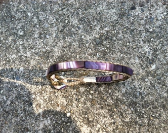 Skinny Flat Bead Wampum Bracelet on a False Sinew Braid. Available on black sinew or natural colored sinew.