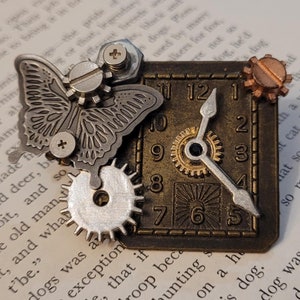 May include: A steampunk-style clock with a butterfly design, gears, and a clock face with Roman numerals. The clock is made of metal and has a bronze finish.
