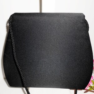 May include: A black satin evening bag with a black braided chain strap.