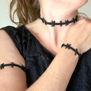 Wearing elastic stitched neck choker, bracelet, and armband