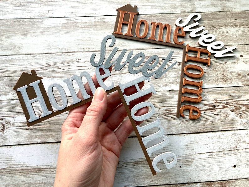 Holding one Home Sweet Home door corner decor with another in the background.