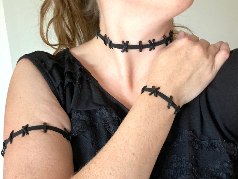 Wearing elastic stitched neck choker, bracelet, and armband