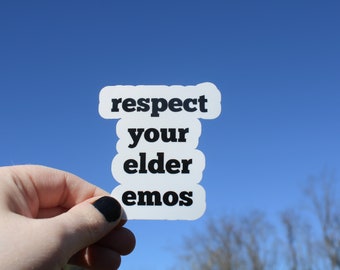 May include: A white sticker with black text that reads "respect your elder emos" held up against a blue sky.