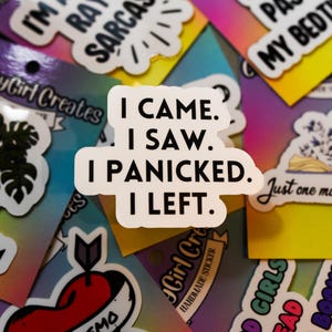 May include: A collection of colorful stickers with various phrases and designs. The stickers include "I'm a little ray of sarcasm", "I came. I saw. I panicked. I left.", "I read past my bedtime", "Still emo", "Good girls", "Just one more chapter", and "Winded Books".